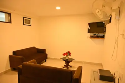 a living room with a couch and a table at Radisson in Madikeri
