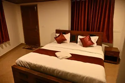 a bedroom with a large bed with red curtains at Radisson in Madikeri