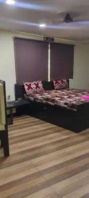 a bedroom with a large bed in a room at Hotel AB Merridien in Coimbatore