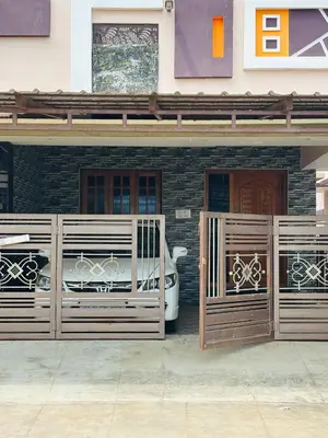 a car parked outside of a house with two gates at RoBen Villa in Pollāchi