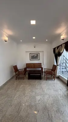 a living room with two benches and a couch at Blessing holidays ooty in Ooty