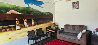 a living room with a mural on the wall at Brighton Hostel Stays in Sultan Bathery