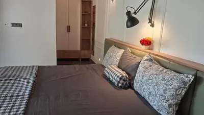 a bed with pillows on it in a bedroom at Vidman Homey Huts in Tindummal