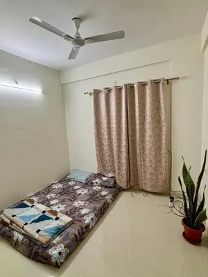 a bedroom with a bed and a ceiling fan at Hazel's ELiTE Homestay 3BHK in Mysore
