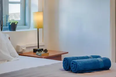 a blue couch sitting on a bed in a bedroom at Zostel Ooty in Ooty