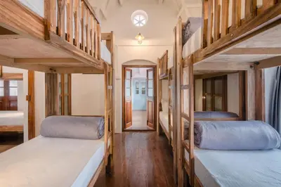 two bunk beds in a room with a hallway at Zostel Ooty in Ooty
