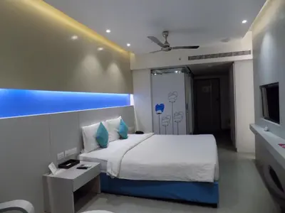 a hotel room with a bed and a tv at ZIBE Coimbatore by GRT Hotels in Coimbatore