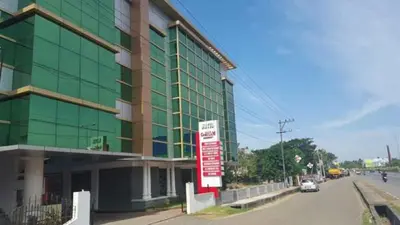 a large green building with a sign in front of it at Sree Gokulam Residency in Trichūr