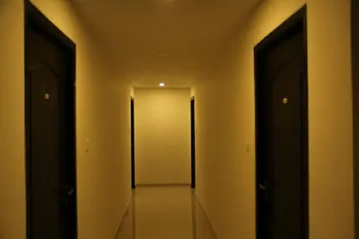 an empty hallway with two doors in a building at Sugam Hotel Pvt Ltd in Coimbatore