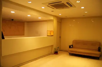 a waiting room with a couch in the corner at Sugam Hotel Pvt Ltd in Coimbatore
