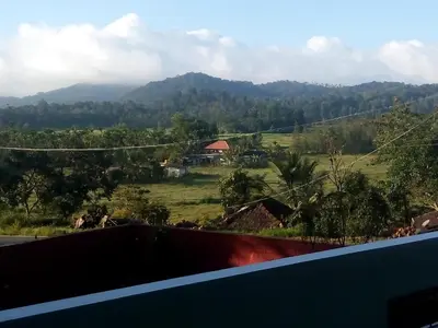 a view from the balcony of a house with mountains at Green Villa in Virajpet