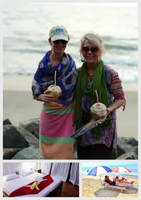 two women standing on the beach with drinks at Cherai Ocean View Home in Cherai Beach