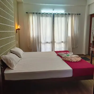 a large bed in a room with a window at Cherai Ocean View Home in Cherai Beach