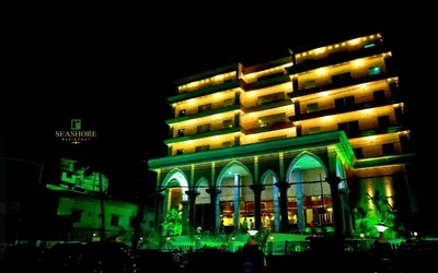 a large building with green lights in front of it at Seashore Residency in Kodungallūr