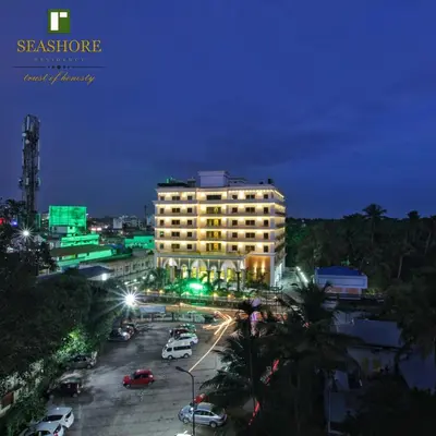 a night view of a large building in a city at Seashore Residency in Kodungallūr