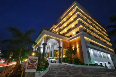 a large building with lights on it at night at Seashore Residency in Kodungallūr