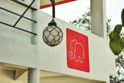 a sign with an elephant on the side of a building at Petit Elephant in Cherai Beach