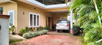 a car parked outside of a house with a driveway at Holidayincoorg Orchid Villa in Madikeri