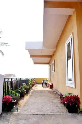 a hallway with potted plants on the side of a building at Holidayincoorg Orchid Villa in Madikeri