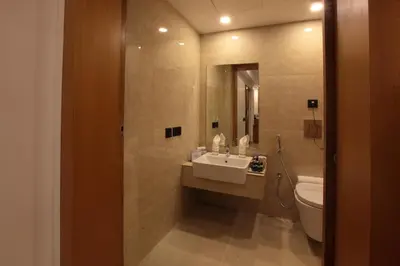 a bathroom with a sink and a toilet at Hotel Park Residency Calicut in Kozhikode