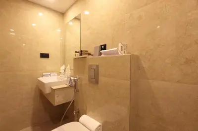 a bathroom with a toilet and a sink at Hotel Park Residency Calicut in Kozhikode