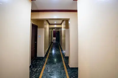 a corridor of a hotel with a long hallway at Hotel Vyshak residency in Mysore
