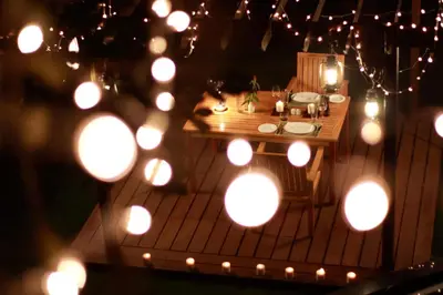 a miniature table with lights on a wooden deck at The IBNII - Eco Luxury Resort in Madikeri