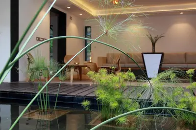 a living room with a lot of plants at The IBNII - Eco Luxury Resort in Madikeri