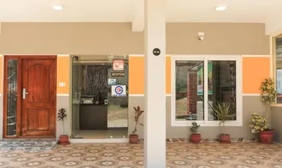 an entrance to a building with a wooden door at Treebo Light House, 900 Mtrs From Botanical Garden in Ooty
