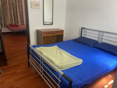 a bedroom with a bed with blue sheets and a mirror at Golf Dale Holiday Resort in Kotagiri