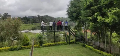 a group of people standing on top of a suspension bridge at Golf Dale Holiday Resort in Kotagiri