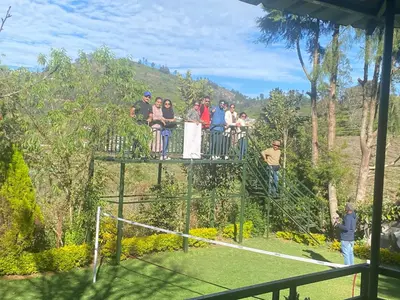 a group of people standing on top of a net at Golf Dale Holiday Resort in Kotagiri