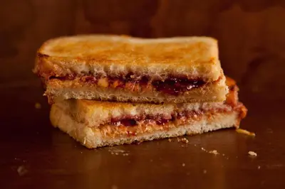 a sandwich cut in half sitting on a table at The Hill Side in Ooty