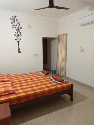 a bedroom with a bed in a room at Ivory Coaste in Kannur