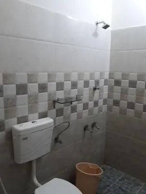 a bathroom with a toilet and a sink at Ivory Coaste in Kannur