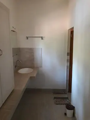 a bathroom with a sink and a toilet at Ivory Coaste in Kannur