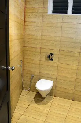 a bathroom with a toilet in a room at Ranis Grand in Coimbatore