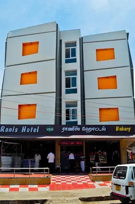 a white van parked in front of a building at Ranis Grand in Coimbatore