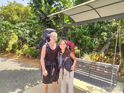 a man and a woman standing in front of a bus stop at Sahyadri Homestay wayanad in Kalpetta