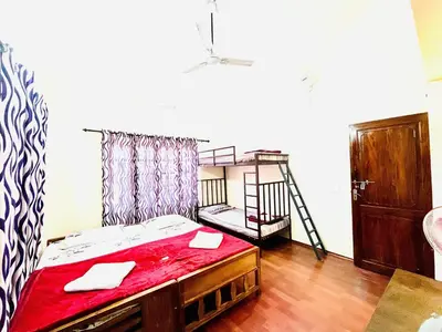 a room with a bed and a bunk bed with a ladder at Sahyadri Homestay wayanad in Kalpetta