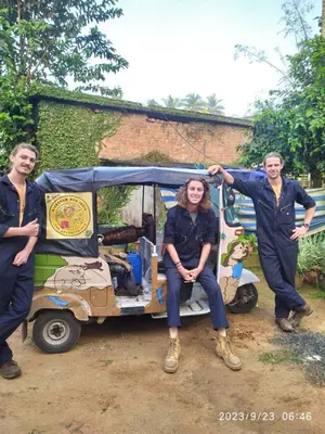 a group of three people standing next to a small vehicle at Sahyadri Homestay wayanad in Kalpetta