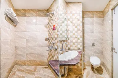 a bathroom with a sink and a toilet at FabHotel Jansi Deluxe - Nr Gandhipuram Bus stand in Coimbatore