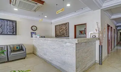 a bar in a lobby with a couch at Treebo Komfort Suites, 3 Km From Mysore Palace in Mysore