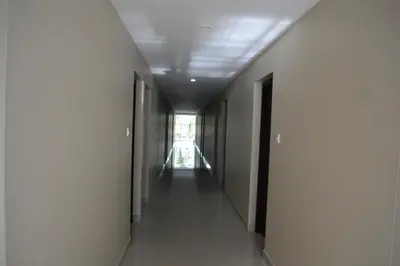 an empty corridor in a building with a long hallway at Dream Land Residency in Mananthavady