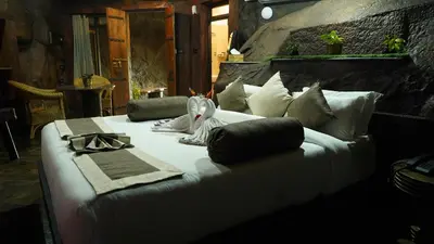 a large white bed with pillows on it at Mount Xanadu Resorts in Ambalavayal