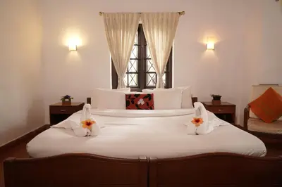a bedroom with a large bed with two bunny pillows at Carpe DiemStay in Kushālnagar