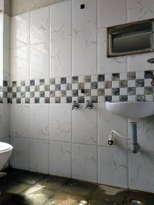 a bathroom with a sink and a mirror at Hotel Ashwini Lodge in Mysore