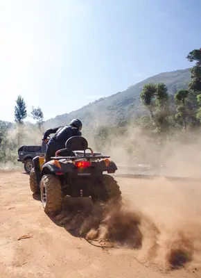 two people riding on a quad bike on a dirt road at Misty Woods Resort in Kakkabe