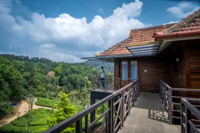 a person standing on the balcony of a house at Wild Planet Jungle Resort in Devāla
