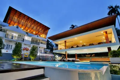 a large house with a swimming pool in front of it at Le Villagio Resort & Domes in Sultan Bathery
